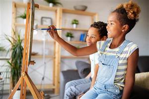 Kids painting on a canvas.